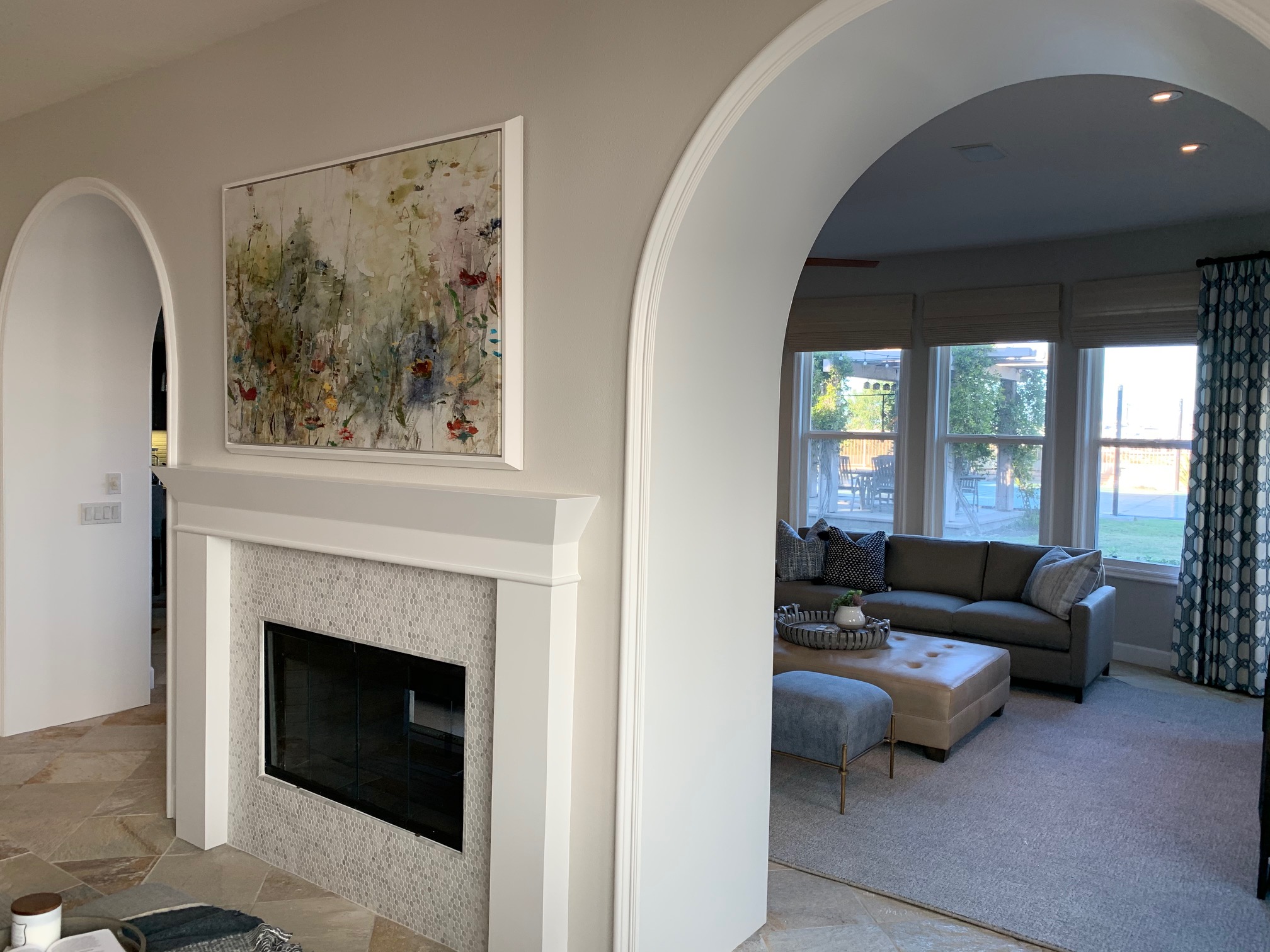 Residential wood archways and modern mantle design in San Diego home